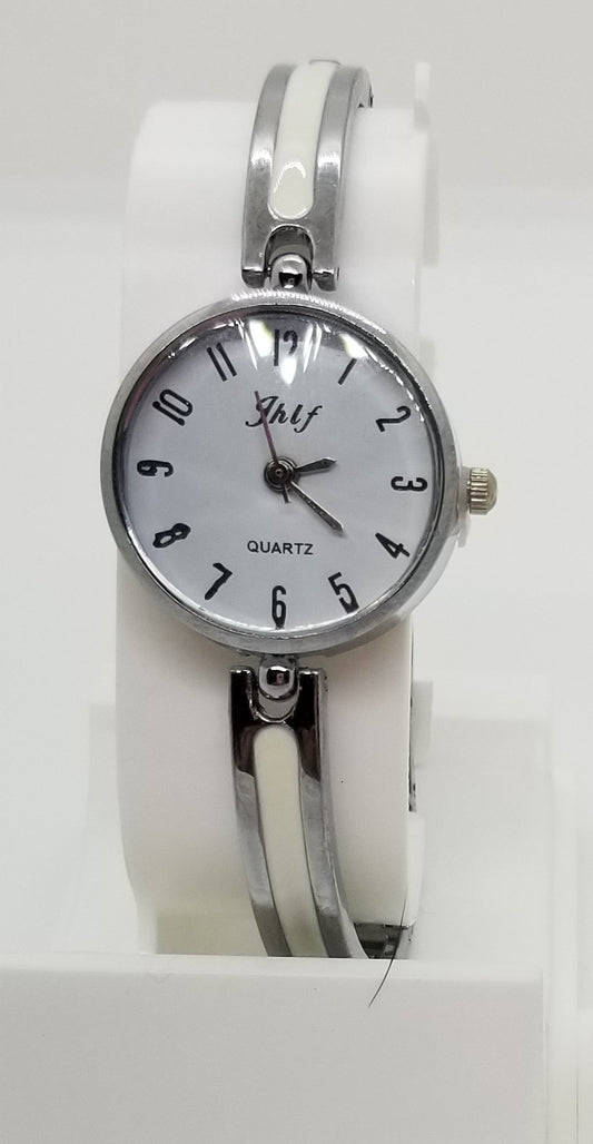 Silver base metal watch with large numbers and a white strip in strap
