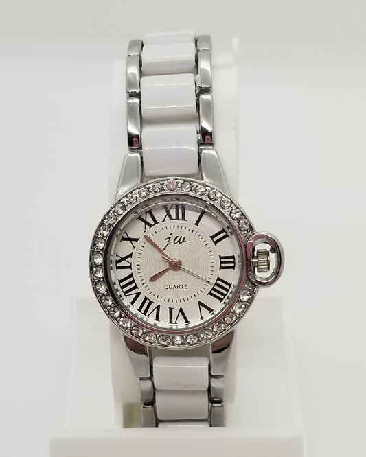 Silver base metal watch with rhinestones around crystal and white in center of strap